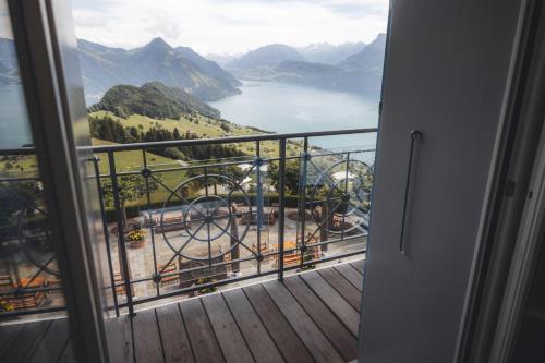 a balcony with a view of a lake and mountains at Hotel Villa Honegg in Ennetbürgen