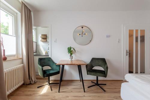 a dining room with a table and two chairs at City Apartment in berühmter Lage in Hildesheim