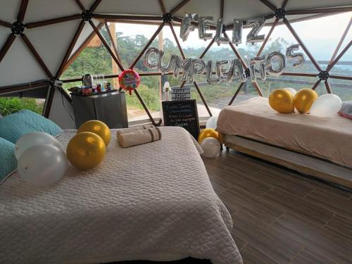 a room with two beds and a sign that says congratulations at Refugio Mirador del Ocaso in Zipacón