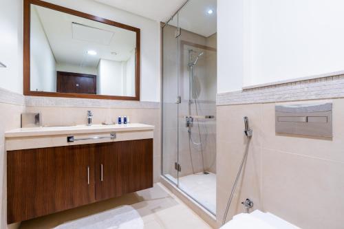 a bathroom with a sink and a shower at Vacay Lettings - High floor Burj Khalifa & Fountain view 3 bed in Dubai