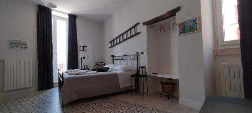a bedroom with a bed and a desk in it at Le Scale di Pietra in Conversano
