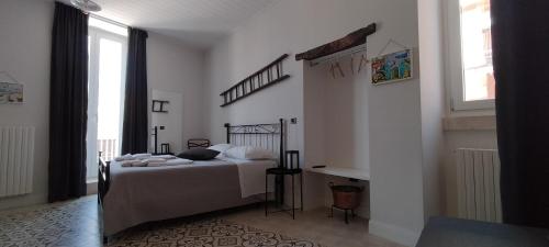 a bedroom with a bed and a large window at Le Scale di Pietra in Conversano