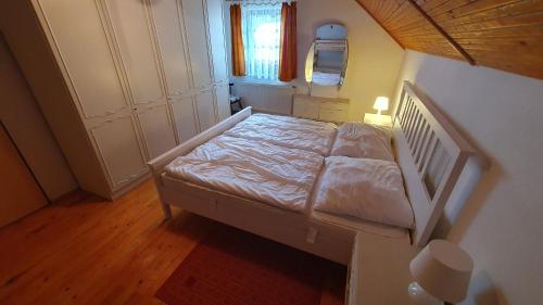 a bedroom with a bed in a room with a window at Hradiste Cottage in Nová Bystřice