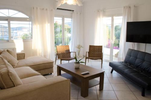 a living room with a couch and a coffee table at Eva's house in Kánithos