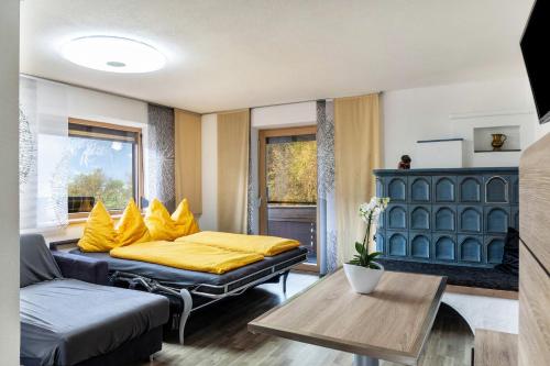a living room with a bed and a couch at Apart Spieljoch 90m2 in Bruck am Ziller
