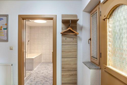 a bathroom with a walk in shower and a door at Apart Spieljoch 90m2 in Bruck am Ziller