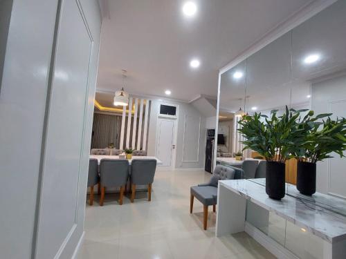 a dining room and living room with a table and chairs at villa batu pandermanhill 4BR+karoke in Tlekung