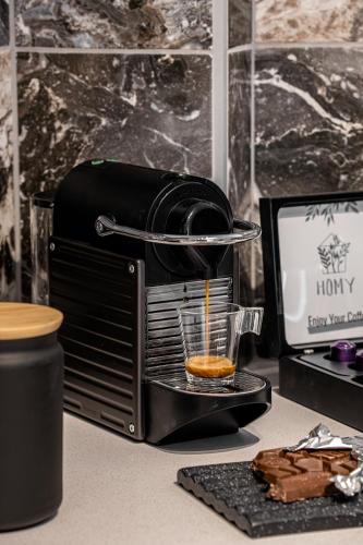 a coffee maker on a desk with a cup of coffee at MACHNE YEHUDA - Exclusive Collection - By HOMY in Jerusalem
