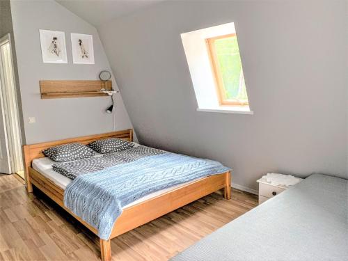 a bedroom with a bed and a window at Beltes Guest House in Jūrmala
