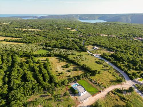 an aerial view of a farm with a river and trees at Villa Lotta in Labin