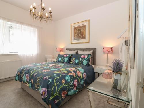 a bedroom with a bed and a glass table at 24 Bridge Street in Banff