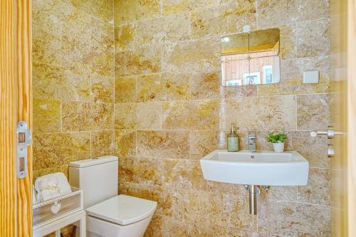 a bathroom with a toilet and a sink at InLoveApartments - Amazing Duplex at Alfama in Lisbon