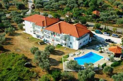 an aerial view of a large house with a swimming pool at Achillion Hotel in Skala Potamias