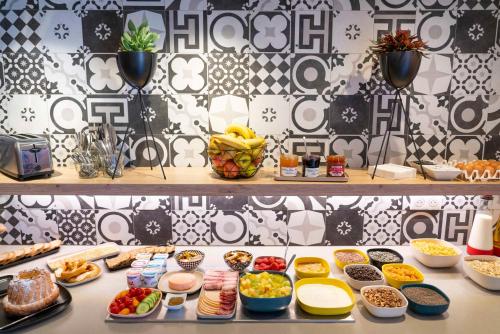 a buffet with many different types of food on a table at Ibis Styles Colmar Centre in Colmar