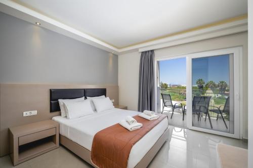 a bedroom with a large bed and a balcony at Vice Hotel in Laganas