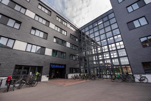 a building with bikes parked in front of it at a&o Copenhagen Sydhavn in Copenhagen