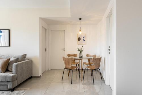 a dining room with a table and chairs and a couch at MACHNE YEHUDA - Exclusive Collection - By HOMY in Jerusalem