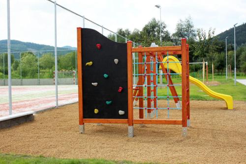 a playground with a climbing frame and a slide at Apartmány U stezek in Lipova Lazne