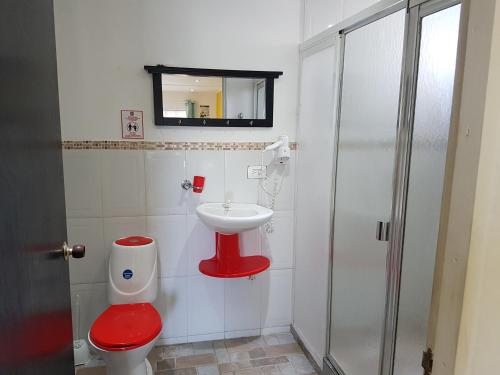 a bathroom with a red toilet and a sink at Posada J&J Forbes - 2 in San Andrés