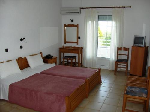 Postel nebo postele na pokoji v ubytování Achillion Hotel