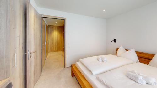 Ein Bett oder Betten in einem Zimmer der Unterkunft Family Holiday Apartment Krone Churwalden