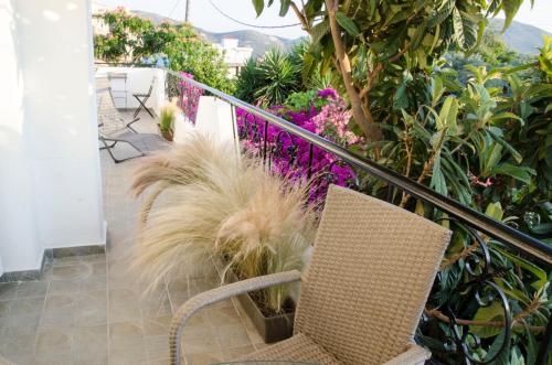 a balcony with a chair and some plants at Eva's house in Kánithos