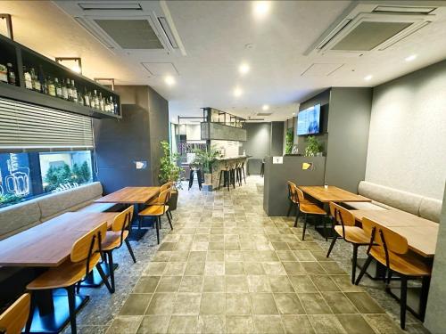 a dining room with wooden tables and chairs at HOTEL SUI AKASAKA by ABEST in Tokyo