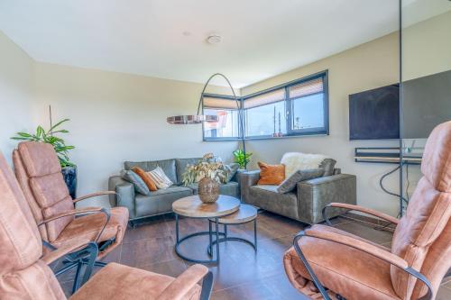 a living room with a couch and chairs at Natuurvilla 18 Waswaal in De Waal