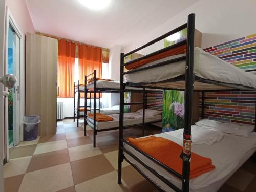 a dorm room with four bunk beds in it at Milano Ostello in Milan