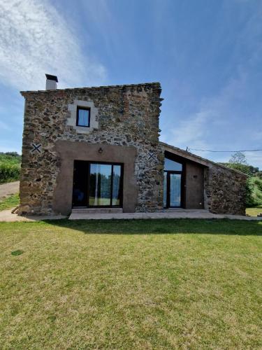 a stone house with a large yard in front of it at Turisme Rural - Mas Vilà - Monells in La Bisbal