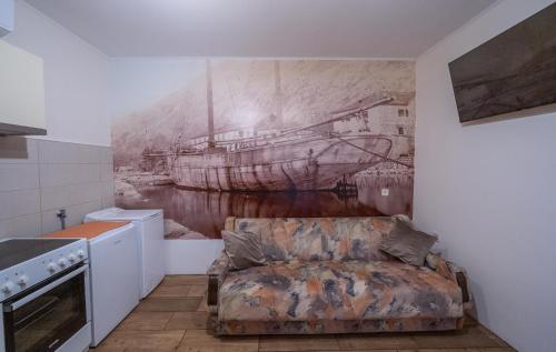 a living room with a painting of a ship on the wall at Regina di Dobrota in Kotor