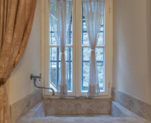 a window with a bath tub in front of it at Regina di Dobrota in Kotor