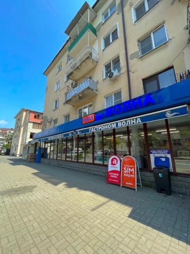 a store on a street in front of a building at Апартаменты Инал-ипа 10 in Sukhum