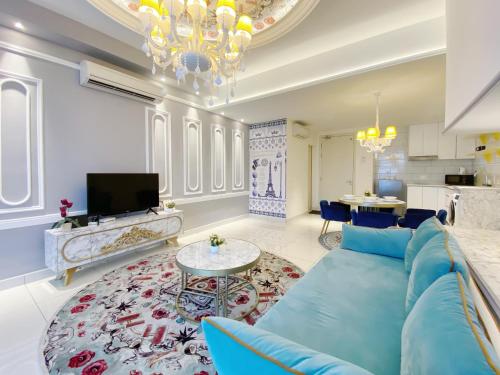 a living room with a blue couch and a table at Arte Mont Kiara By The Relax Stay Kualalumpur in Kuala Lumpur