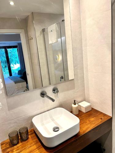 a bathroom with a white sink and a mirror at Hostal del vino LA COSTERA in Altea