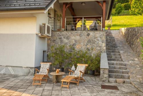 a group of chairs and a table on a patio at Vineyard cottage Jelenov hrib in Smarjeske Toplice
