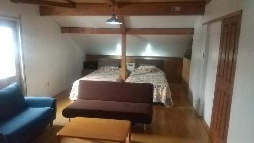 a room with a bed and a couch in a room at Ski base in Akaigawa