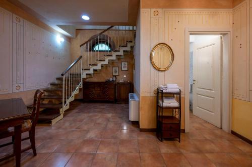 a hallway with a staircase in a house at Hotel Airone in Piadena