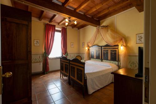 a bedroom with a bed with a canopy at Hotel Airone in Piadena