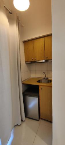 a small kitchen with a sink and a counter at Kiperi Exclusive in Parga