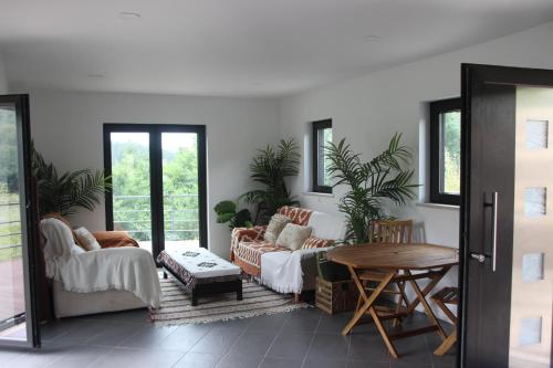 a living room with two couches and a table at Casa do Rio in Treixedo