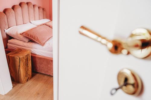 a bedroom with a bed and a bathroom with a sink at OSADA LEŚNA - domki z basenem in Stare Miasto