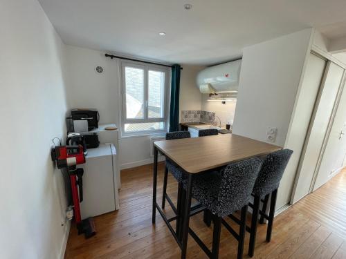 une cuisine et une salle à manger avec une table et des chaises dans l'établissement Les 4 saisons Honfleur - Studio 3, à Honfleur