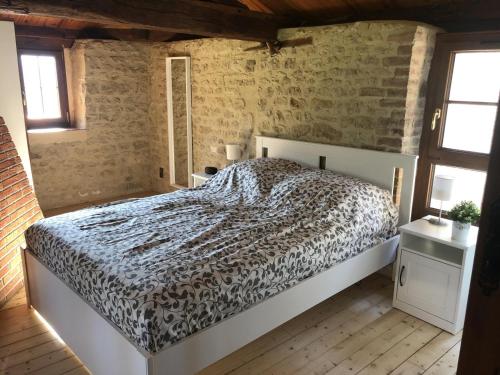 a bedroom with a bed in a brick wall at La ferte 