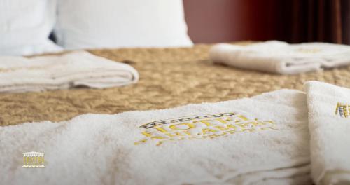 a close up of a white towel on a bed at Hotel Parlament in Pristina