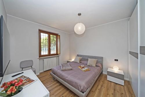 a small bedroom with a bed and a table at Casa Monte Cicogna PT-1 by Wonderful Italy in Moniga