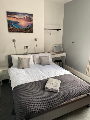 a bedroom with a large bed with a towel on it at The Victoria in Saltburn-by-the-Sea