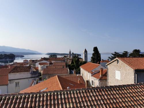 a view from the roofs of a town at Deluxe Apartment "Sunset in Barbat" with sea view in Rab