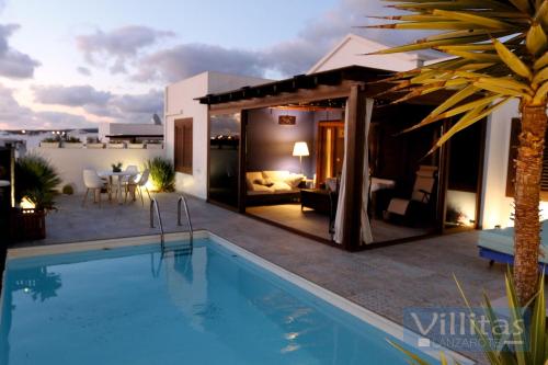 a villa with a swimming pool in a backyard at VILLAZUL by Villitas in Playa Blanca