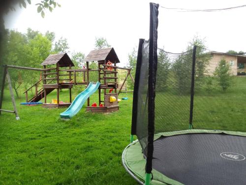 a park with a playground with a slide and swings at Szałas, Namiot w Górach Izerskich, agroturystyka, ogrzewanie, klimatyzacja , plac zabaw, ognisko z rusztem i kijkami, żywe zwierzęta, latem basen in Mirsk